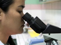 lady looking through microscope